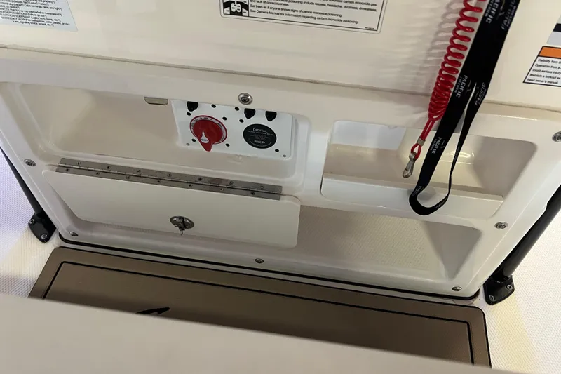 Slide: The Image of 2023 Robalo R200 Center Console boat dashboard with control panel and safety lanyard. - 45