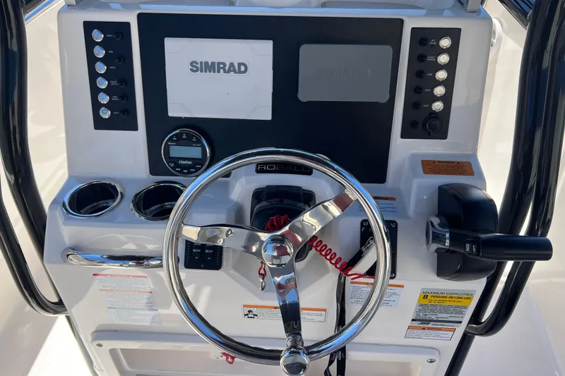 Slide: The Image of 2023 Robalo R200 Center Console dashboard with steering wheel and Simrad display. - 8