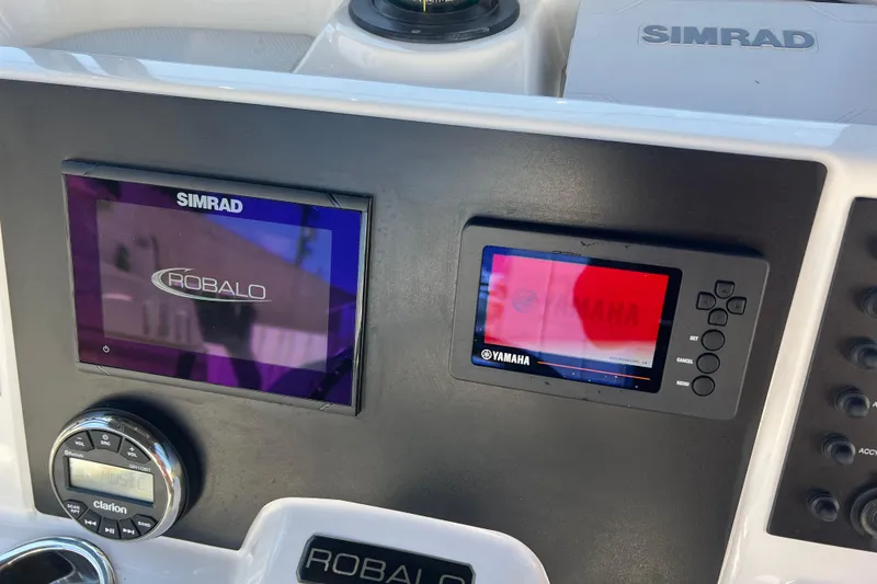 Slide: The Image of 2023 Robalo R200 Center Console dashboard with Simrad and Yamaha displays. - 9