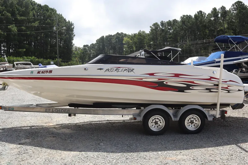 Slide: The Image of 2007 Caravelle Interceptor 232SS Bow Rider on trailer, featuring red and black graphics. - 1