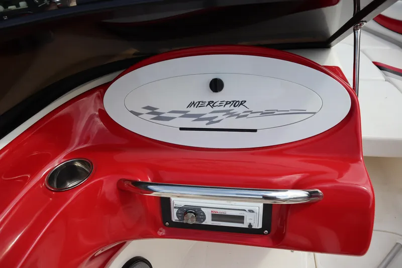 Slide: The Image of 2007 Caravelle Interceptor 232SS Bow Rider dashboard with red accents and stereo system. - 14