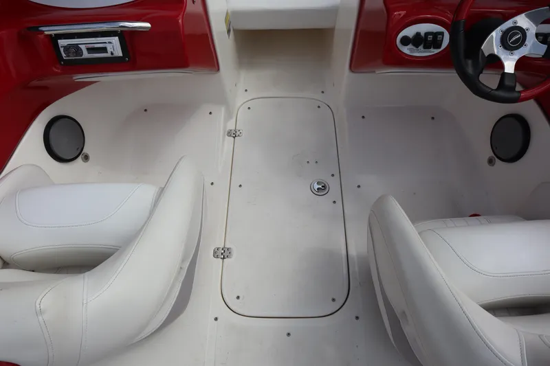 Slide: The Image of 2007 Caravelle Interceptor 232SS Bow Rider interior with white seats and red dashboard. - 18