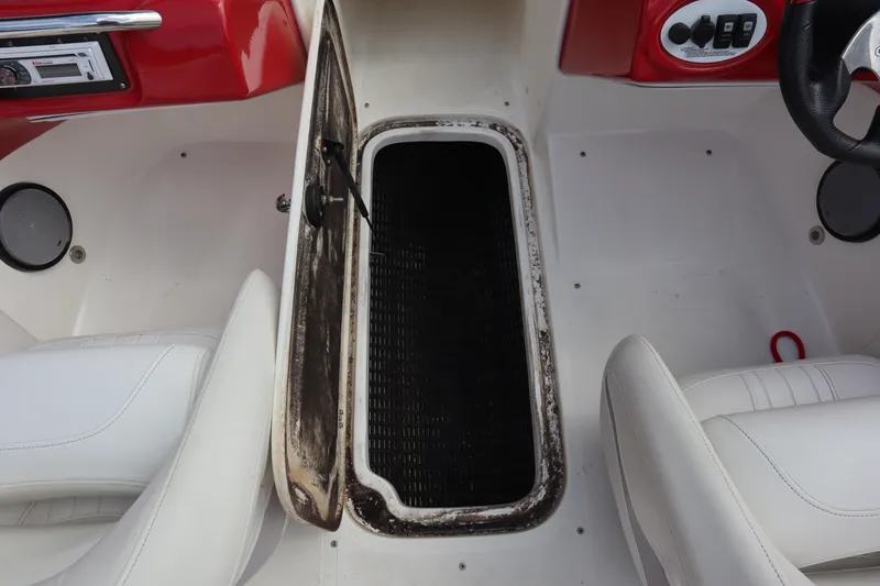 Slide: The Image of 2007 Caravelle Interceptor 232SS Bow Rider interior with open storage compartment. - 19