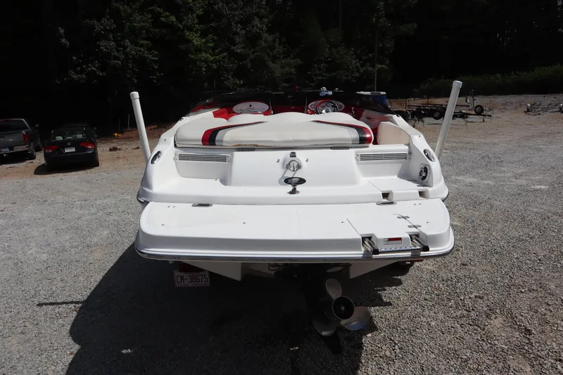 Slide: The Image of 2007 Caravelle Interceptor 232SS Bow Rider, rear view, parked on gravel. - 2