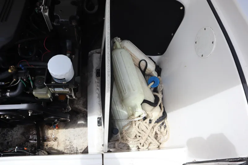 Slide: The Image of Engine compartment of 2007 Caravelle Interceptor 232SS Bow Rider with ropes and containers. - 24