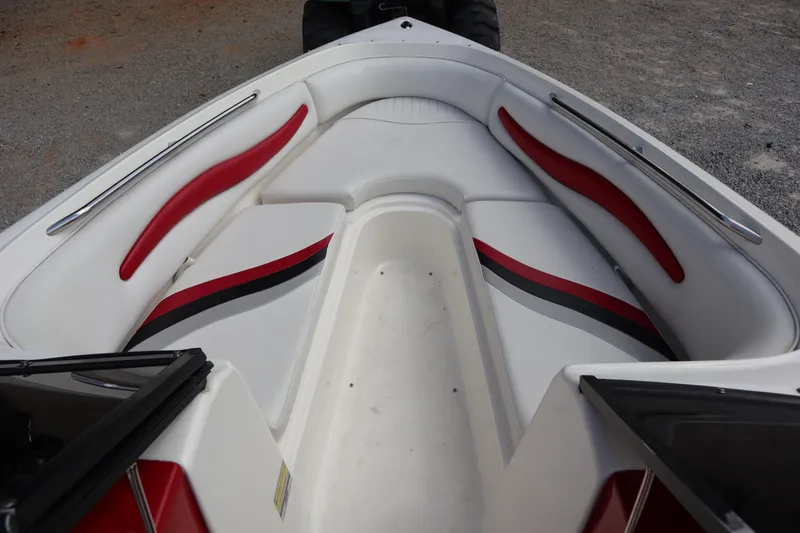 Slide: The Image of 2007 Caravelle Interceptor 232SS Bow Rider interior with red and black accents. - 4