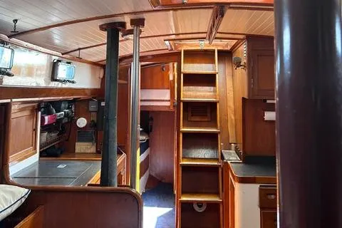 Slide: The Image of Interior of 1972 Cheoy Lee Offshore 47 Yawl, featuring wooden cabinetry and nautical design. - 18