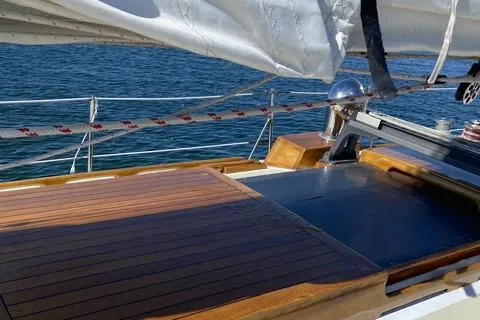 Slide: The Image of 1972 Cheoy Lee Offshore 47 Yawl deck with wooden finish and sail details. - 23