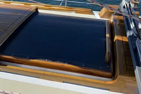 Slide: The Image of 1972 Cheoy Lee Offshore 47 Yawl deck with wooden trim and black cover. - 26