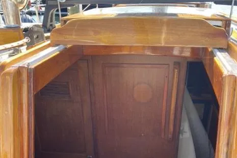 Slide: The Image of 1972 Cheoy Lee Offshore 47 Yawl cabin entrance with polished wood finish. - 28