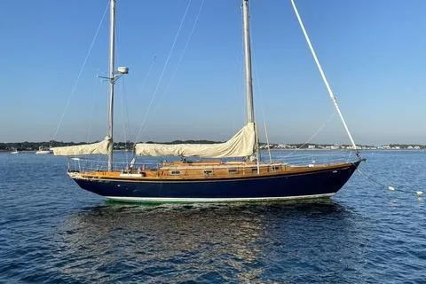 Slide: The Image of 1972 Cheoy Lee Offshore 47 Yawl sailing on calm waters under a clear blue sky. - 33