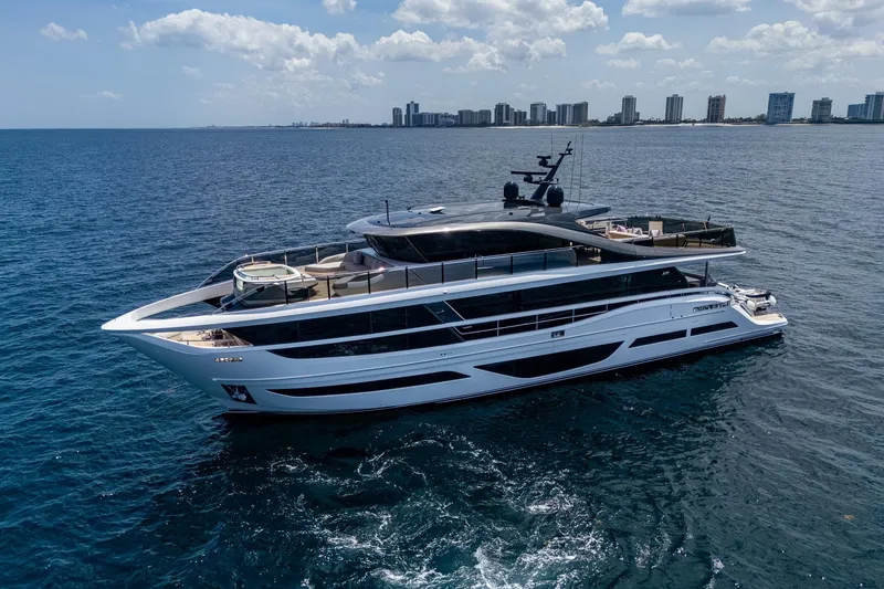 Slide: The Image of Luxurious 2022 Princess X95 yacht cruising on open sea with city skyline backdrop. - 39