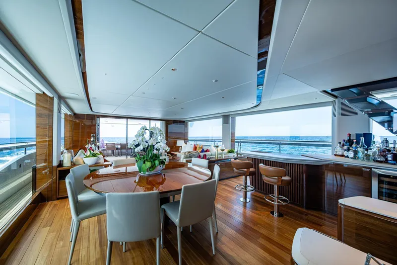 Slide: The Image of Luxurious interior of 2022 Princess X95 yacht with ocean view, elegant dining, and bar area. - 65
