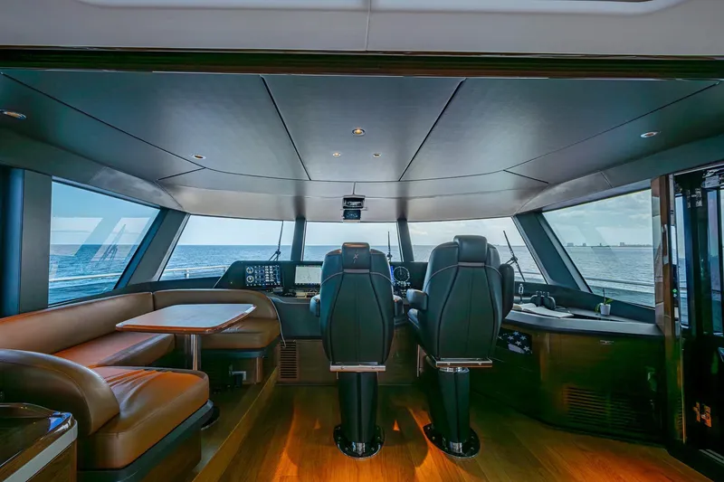 Slide: The Image of Luxurious 2022 Princess X95 yacht interior with ocean view, featuring modern helm and seating area. - 88