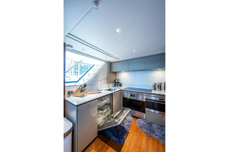 Slide: The Image of Modern kitchen interior on 2022 Princess X95 yacht, featuring sleek appliances and wooden flooring. - 94