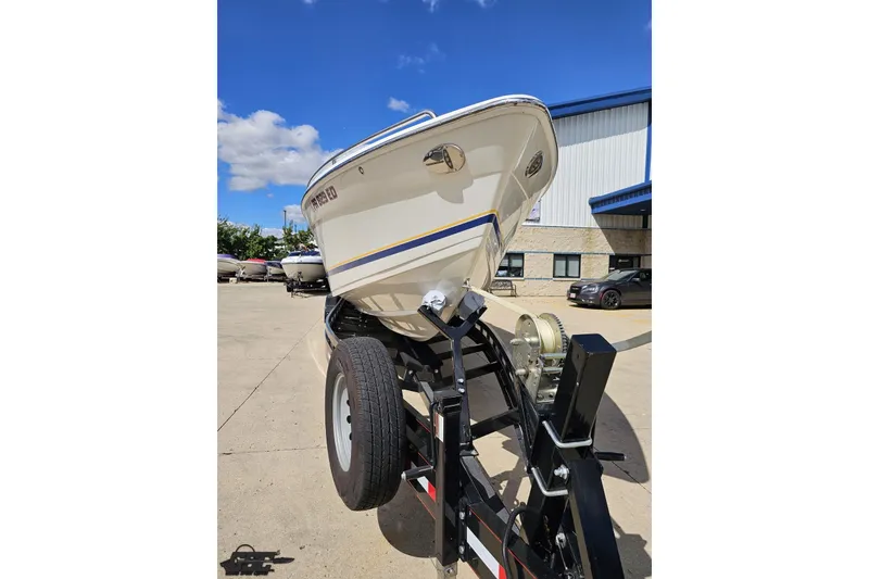 Slide: The Image of 2012 Formula 382 FASTech boat on trailer, parked outdoors under blue sky. - 10