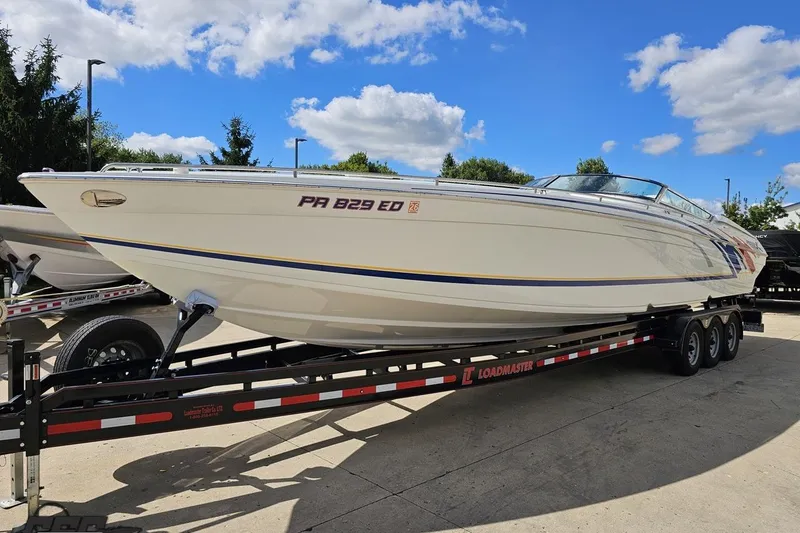 Slide: The Image of 2012 Formula 382 FASTech boat on Loadmaster trailer under blue sky. - 11