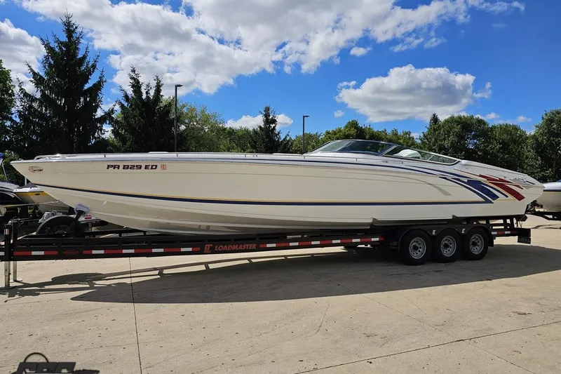 Slide: The Image of 2012 Formula 382 FASTech boat on trailer, parked outdoors under a blue sky. - 12