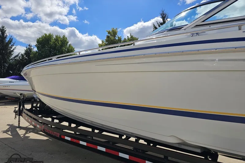 Slide: The Image of 2012 Formula 382 FASTech boat on trailer under blue sky. - 16
