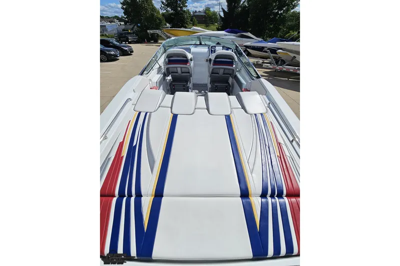 Slide: The Image of 2012 Formula 382 FASTech boat with colorful striped upholstery, parked outdoors. - 24