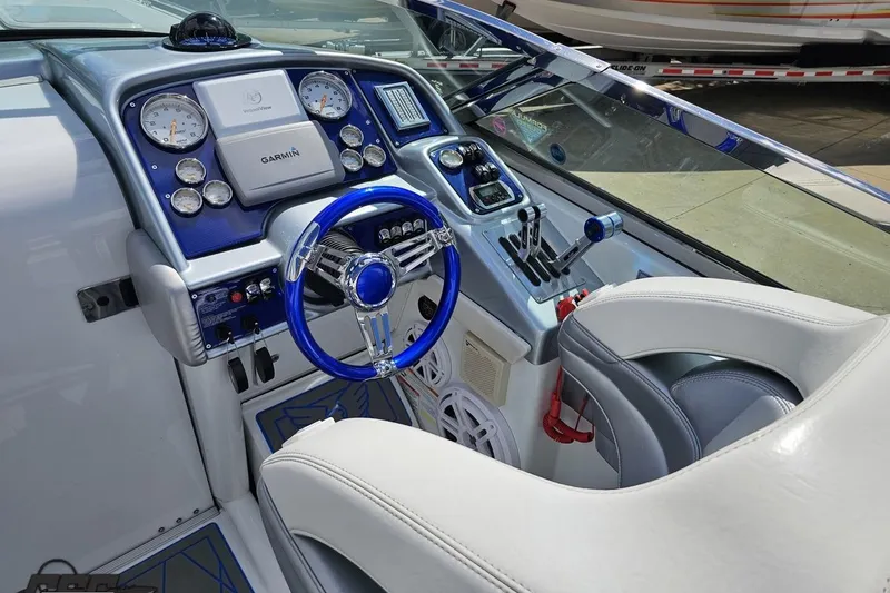 Slide: The Image of 2012 Formula 382 FASTech boat cockpit with blue steering wheel and Garmin navigation system. - 35