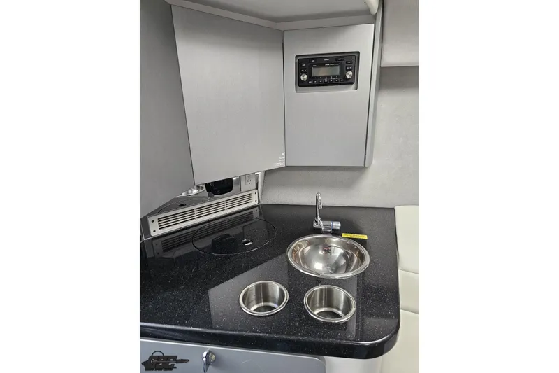 Slide: The Image of 2012 Formula 382 FASTech boat interior with kitchenette, sink, and stereo system. - 59