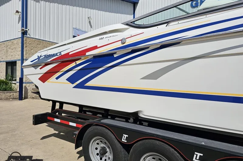 Slide: The Image of 2012 Formula 382 FASTech boat with vibrant graphics on a trailer. - 7