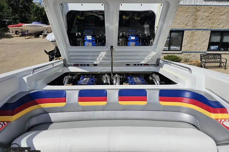 Slide: The Image of 2012 Formula 382 FASTech boat engine compartment with vibrant upholstery and dual engines. - 75