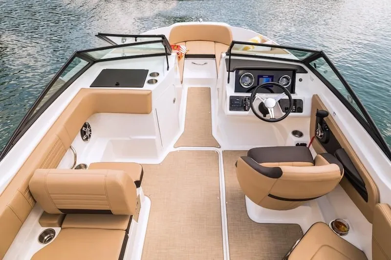 Slide: The Image of 2019 Sea Ray SPX 210 OB boat interior with tan seating and modern dashboard. - 32