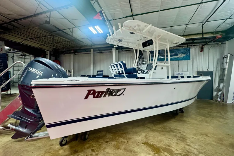 Slide: The Image of 2026 Parker 23SE Center Console boat with Yamaha engine in showroom. - 1