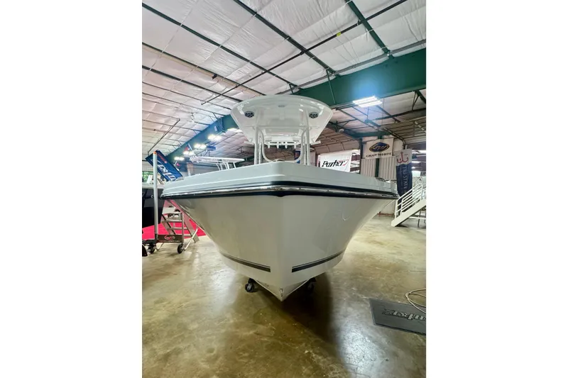 Slide: The Image of 2026 Parker 23SE Center Console boat displayed indoors, showcasing sleek design and modern features. - 2