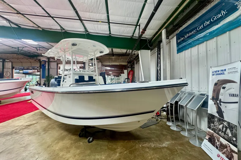 Slide: The Image of 2026 Parker 23SE Center Console boat displayed in a showroom with Yamaha advertisement. - 3