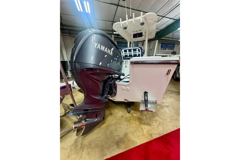Slide: The Image of 2026 Parker 23SE Center Console with Yamaha outboard motor in showroom. - 4