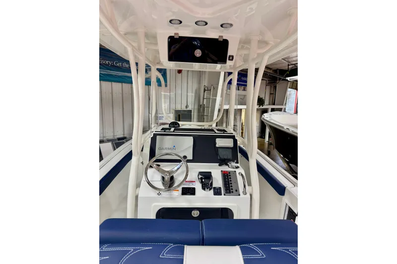 Slide: The Image of 2026 Parker 23SE Center Console boat interior with steering wheel and Garmin navigation system. - 6