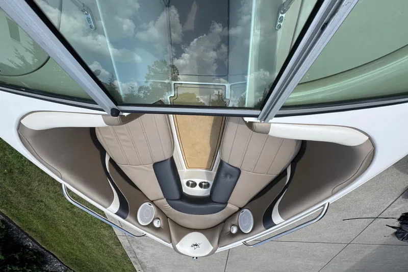 Slide: The Image of 2002 MasterCraft ProStar 209 boat interior with beige seating and cup holders. - 11