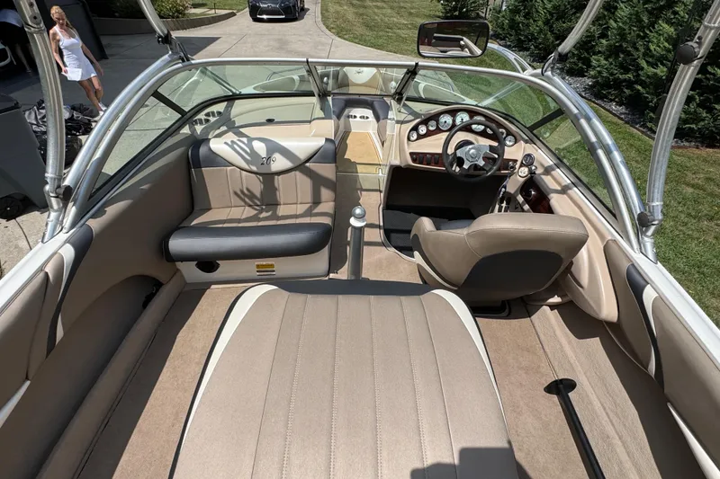 Slide: The Image of 2002 MasterCraft ProStar 209 boat interior with beige seating and dashboard. - 15