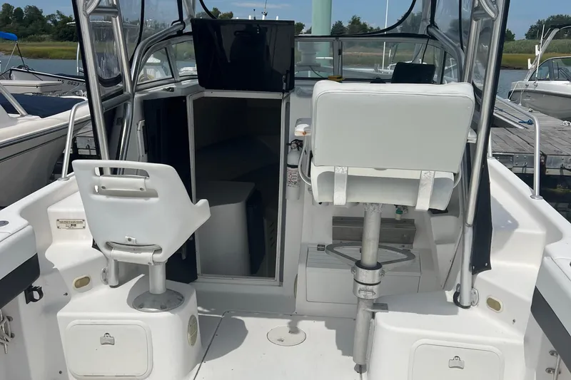 Slide: The Image of 2002 Angler 2500 WA boat interior with seating and cabin entrance. - 10