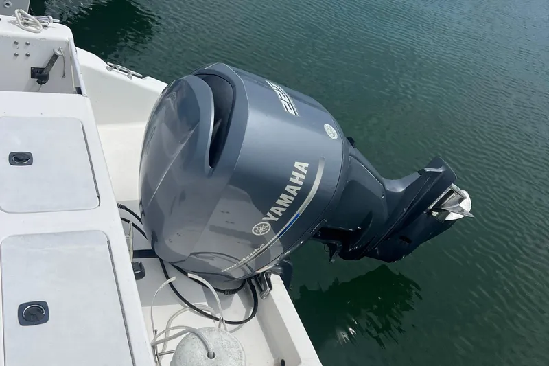 Slide: The Image of Outboard motor on 2002 Angler 2500 WA boat, Yamaha engine, docked on calm water. - 6
