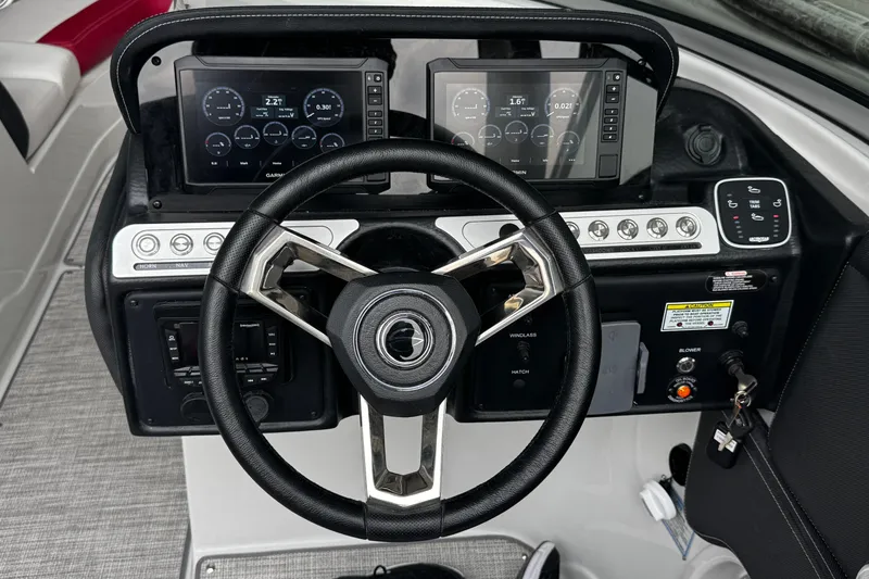 Slide: The Image of 2026 Crownline 298 SS boat dashboard with steering wheel and digital displays. - 10