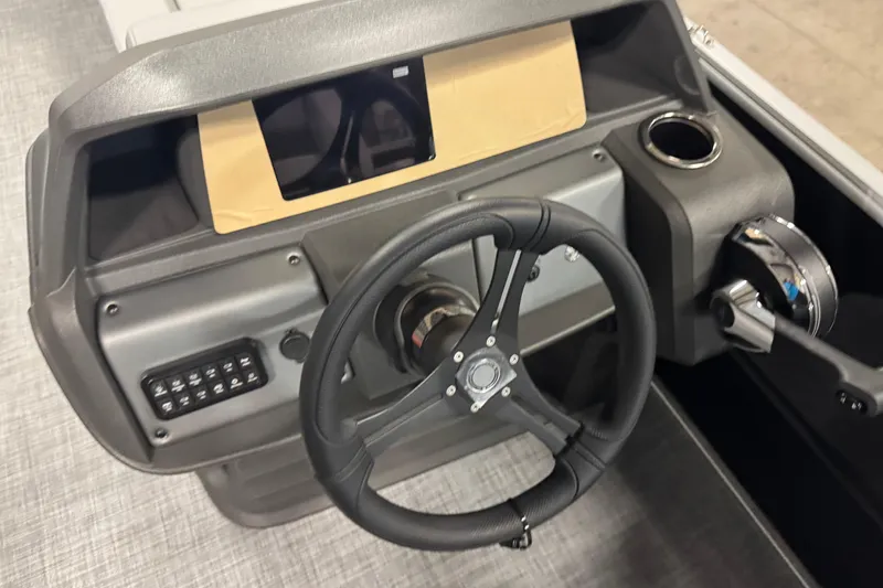Slide: The Image of 2026 Sun Tracker Party Barge 20 DLX steering console with modern controls and cup holder. - 14