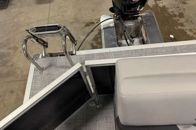 Slide: The Image of 2026 Sun Tracker Party Barge 20 DLX with motor and seating area, viewed from above. - 16