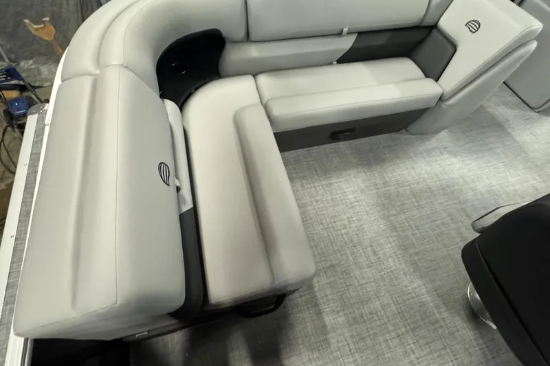 Slide: The Image of 2026 Sun Tracker Party Barge 20 DLX interior seating with gray upholstery and modern design. - 17
