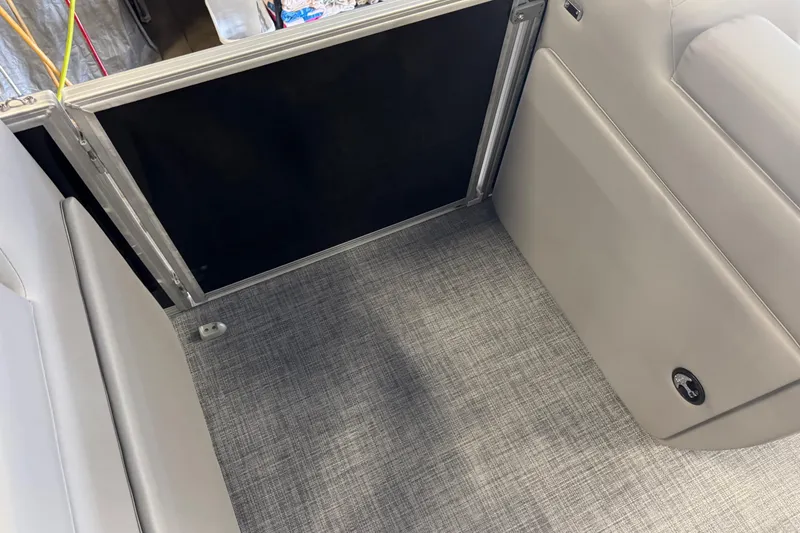 Slide: The Image of Interior view of 2026 Sun Tracker Party Barge 20 DLX with gray flooring and seating. - 18