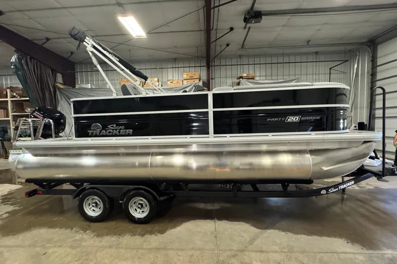 Slide: The Image of 2026 Sun Tracker Party Barge 20 DLX pontoon boat in a warehouse setting. - 3