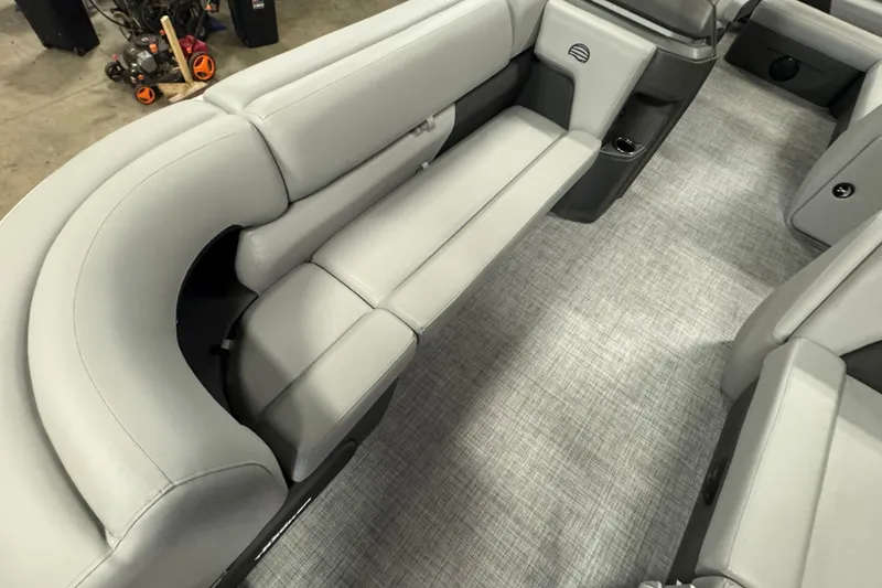 Slide: The Image of 2026 Sun Tracker Party Barge 20 DLX interior with gray seating and carpeted flooring. - 7