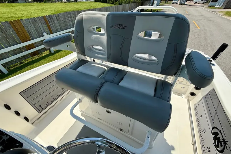 Slide: The Image of 2022 NauticStar 251 Hybrid boat seating with gray upholstery and armrests. - 10