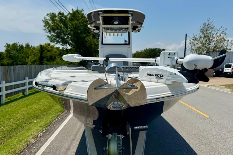 Slide: The Image of 2022 NauticStar 251 Hybrid boat with Minn Kota Terrova motor on a sunny day. - 6