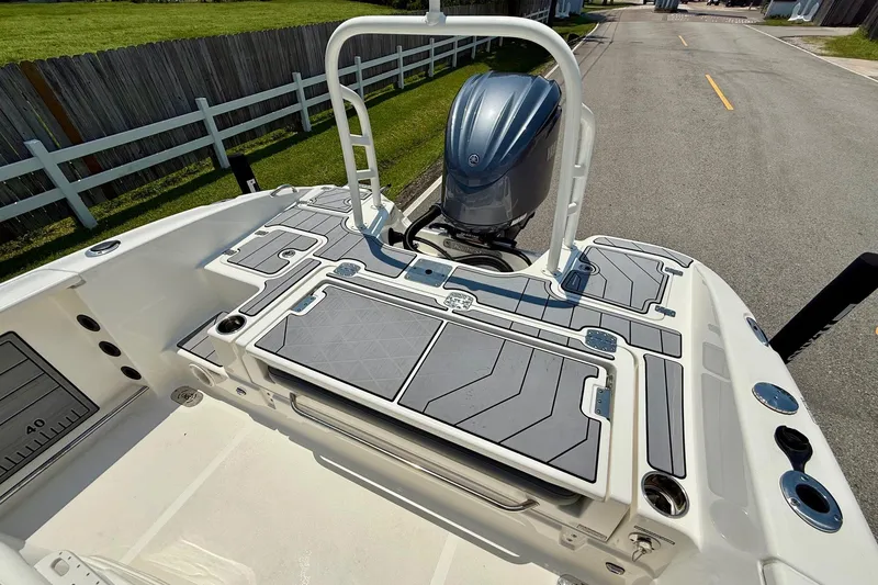 Slide: The Image of 2022 NauticStar 251 Hybrid boat deck with engine, featuring sleek design and modern fittings. - 8