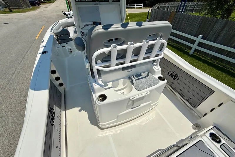 Slide: The Image of 2022 NauticStar 251 Hybrid boat interior with rod holders and seating. - 9
