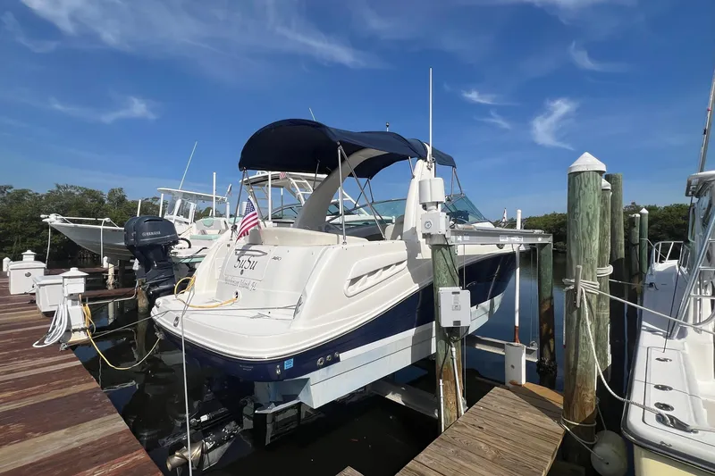 Slide: The Image of 2005 Sea Ray 260 Sundancer docked at marina under clear blue sky. - 5
